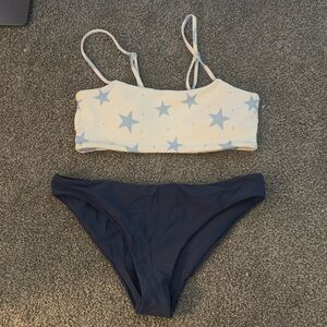 starry bikini top and dark blue bikini bottoms